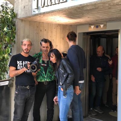 Piero Pelù et al. standing in front of a building