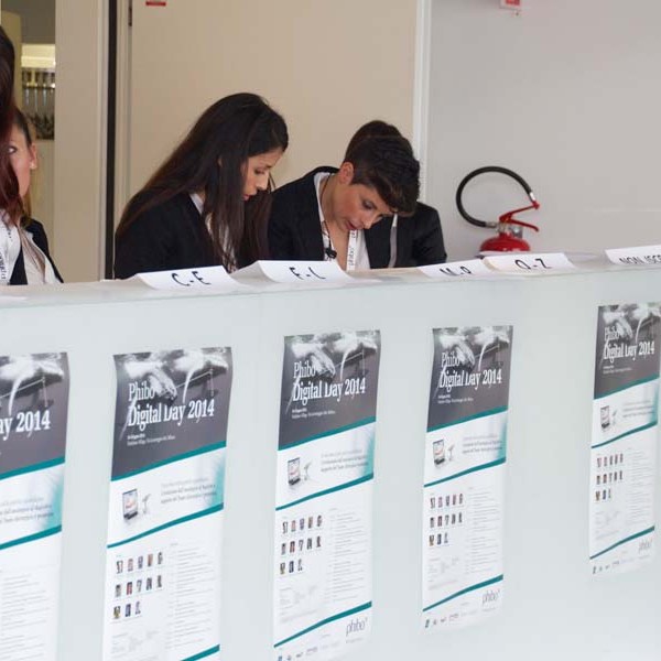 People at a registration desk with 'Phibo Digital Day 2014' posters displayed.