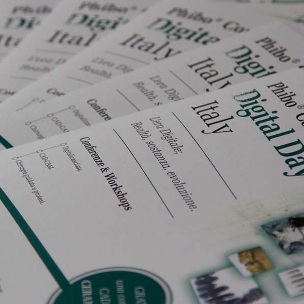 Stack of pamphlets titled 'Phi-bo @ Congress Digital Day Italy' with workshop details.